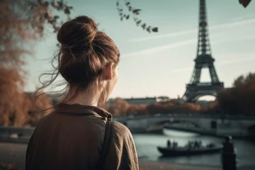 Selbstklebende Fototapete Eiffelturm The back view of a woman looking at the scenery in front of the Eiffel Tower, an example of a faceless person, a girl on a summer trip, people's back material, European travel, INS photo, Eiffel Tower