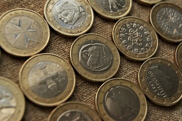 1 euro coins on natural linen fabric. Bimetallic European coins obverse.