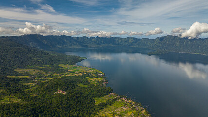 Naklejka na ściany i meble Aerial drone of blue lake Maninjau in a crater among the mountains. Sumatra, Indonesia.