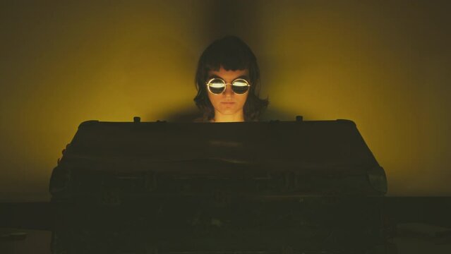 Movie like cinematic scene, young woman opening and closing a mysterious suitcase with a glowing golden treasure hidden inside. Treasure chest, smuggler, spy or thief concept. 
