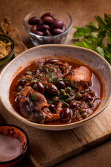stewed polyps with tomato sauce black olives capers and parsley
