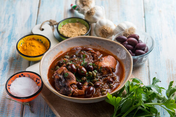 stewed polyps with tomato sauce black olives capers and parsley