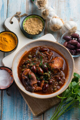 stewed polyps with tomato sauce black olives capers and parsley