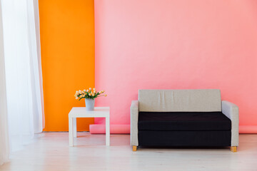 sofa coffee table with flowers on pink orange background