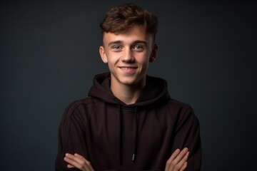 Naklejka premium Medium shot portrait photography of a joyful boy in his 20s wearing a comfortable tracksuit against a dark grey background. With generative AI technology