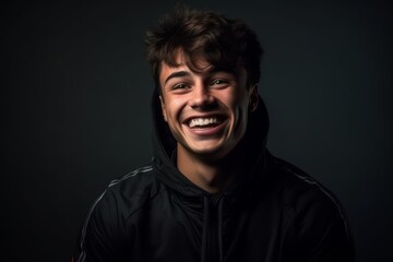 Fototapeta premium Medium shot portrait photography of a joyful boy in his 20s wearing a comfortable tracksuit against a dark grey background. With generative AI technology