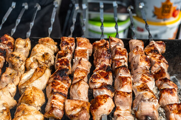 Meat on skewers is cooked on coals.