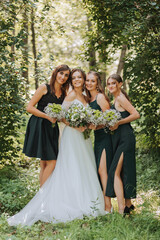 A bride celebrates her wedding with friends outdoors after the ceremony