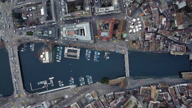 Zurich, Switzerland: Overhead drone footage of the Limmat river in Zurich medieval old town and business and financial district in Switzerland largest city in the evening. 