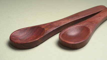 Empty wooden bowl and wooden spoon isolated with copy space.
