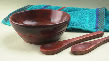 Empty wooden bowl and wooden spoon isolated with copy space.