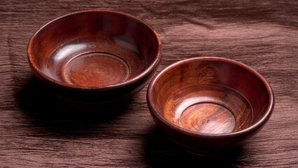 Empty wooden bowl and wooden spoon isolated with copy space.