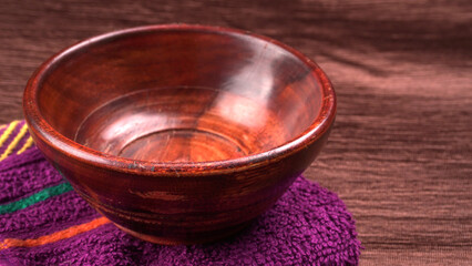 Empty wooden bowl and wooden spoon isolated with copy space.