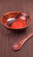 Empty wooden bowl and wooden spoon isolated with copy space.