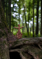 magic witch doll made of tree bast in forest, dark natural background. Forest grandmother, defender...