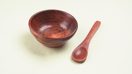 Empty wooden bowl and wooden spoon isolated with copy space.