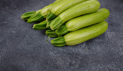 Fresh zucchini, green vegetables on local farmer market freshly harvested courgette, summer squash. raw in salads or cooked, extremely versatile, tender and easy to include in many light dishes