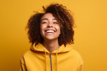 Obraz na płótnie Canvas Medium shot portrait photography of a grinning girl in her 30s wearing a cozy zip-up hoodie against a yellow background. With generative AI technology