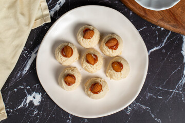Almond and caramel cookies. Almond cookies on dark background. Top view