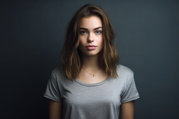 Fototapeta premium Medium shot portrait photography of a glad girl in her 20s wearing a casual t-shirt against a metallic silver background. With generative AI technology
