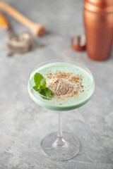 Grasshopper cocktail  from New Orleans, with green mint liqueur, chocolate liqueur and cream in cocktail glass.