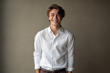 Obraz premium Medium shot portrait photography of a grinning boy in his 20s wearing an elegant long-sleeve shirt against a minimalist or empty room background. With generative AI technology