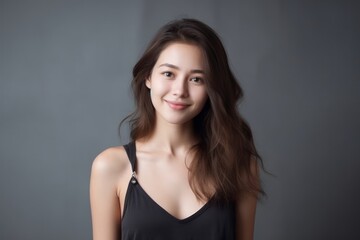 Fototapeta premium Close-up portrait photography of a satisfied girl in her 20s wearing a chic jumpsuit against a minimalist or empty room background. With generative AI technology