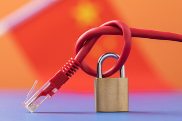 Closed lock on a network wire on the background of the flag, a concept on the theme of the closed Internet in China