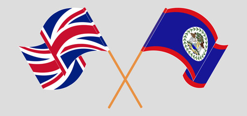 Crossed and waving flags of United Kingdom and Belize