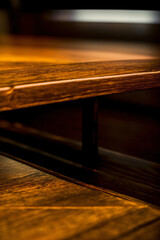 A Close Up Of A Wooden Table With A Blurry Background