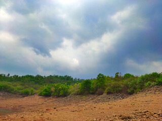Rain and sun through the clouds over the green summer Carpathian foggy green mountain hills. Rainy evening panorama.