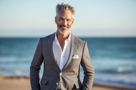 Urban fashion portrait photography of a satisfied mature man wearing a classic blazer against a beach background. With generative AI technology