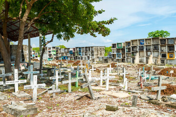 Fototapeta na wymiar Oslob Public Cemetery,stacked tombs and crowded graveyard,under the baking sun,Oslob, Cebu Province, Central Visayas, Philippines.