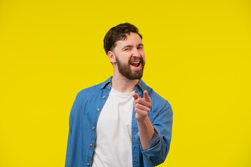 Adult man smiling, winking and pointing his finger at the camera