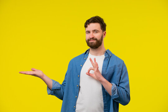 Man With Open Hand Showing An Ok Gesture And Smiling At The Camera