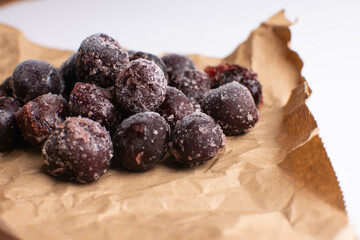 Frozen cherries on a sheet of craft paper