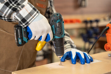 Close up shot, Male carpenter driling wood at factory. Carpenter, Handcraft, Industrial, Factory...