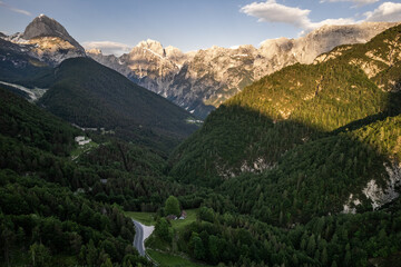 Alpine landscape with green forest in Predil Pass, Italy and Slovenia. Aerial drone view