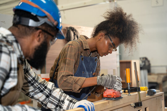 Team carpenter working in a woodworking workshop. They is focused on working in the factory. Carpenter, Handcraft, Industrial, Factory and Engineer concept.