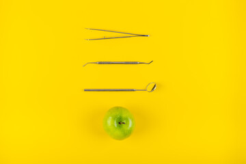 Dental tools set with green apple for healthy teeths