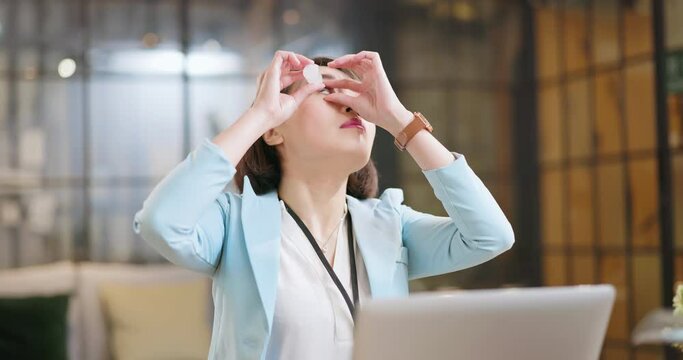 woman eyes pain at work