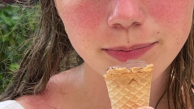 A child eats ice cream in a close-up frame