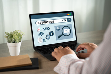 keywords on a website for content businessman Search keywords on a laptop, browse in the office, optimize SEO engine communication on the computer, find data analysis, and advertise on the internet.