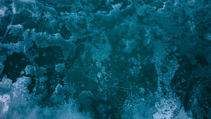 Fototapeta na wymiar Ice crust on the surface of a mountain lake