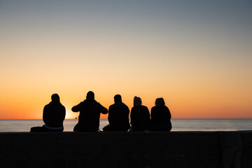 Fototapeta na wymiar Freunde genießen gemeinsam den Sonnenuntergang