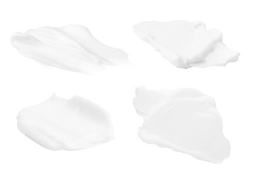 A set of different strokes of white cream on a blank background. PNG