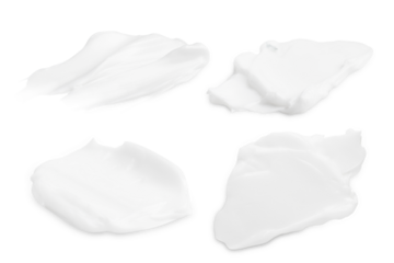 A set of different strokes of white cream on a blank background. PNG