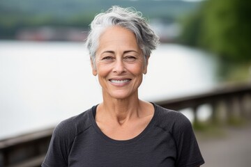Three-quarter studio portrait photography of a satisfied mature woman wearing a casual t-shirt against a riverfront background. With generative AI technology