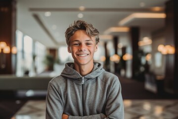 Obraz premium Close-up portrait photography of a joyful mature boy wearing soft sweatpants against a swanky hotel lobby background. With generative AI technology