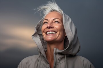Casual fashion portrait photography of a grinning mature woman wearing a stylish hoodie against a dramatic thunderstorm background. With generative AI technology
